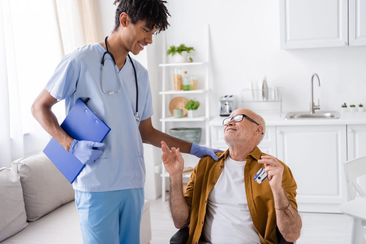 Community Health Integration (CHI) provider supporting elderly patient during home visit to improve care access.