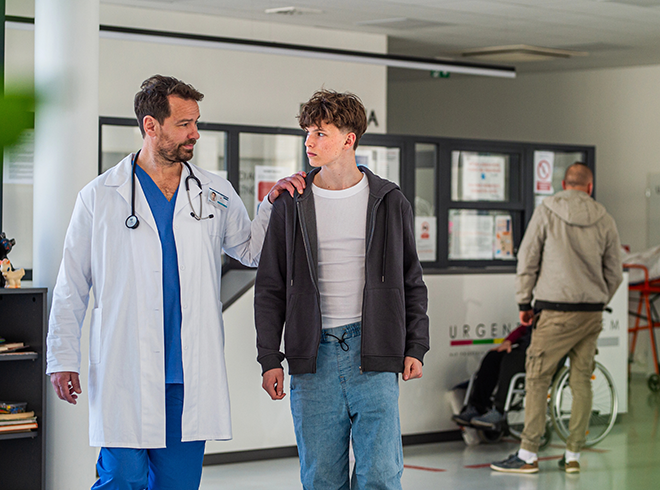 Doctor supporting teenage patient in hospital setting, illustrating youth care engagement, trauma-informed support, and compassionate clinical interaction