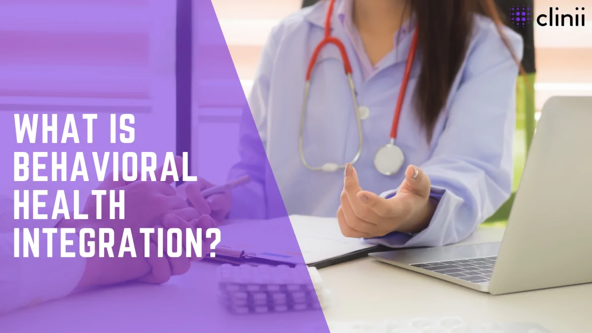 A female doctor wearing a lab coat and red stethoscope gestures while sitting at a desk with a laptop, paperwork, and a patient’s hand visible. The overlaid title reads “What Is Behavioral Health Integration?” with the Clinii logo in the top right.
