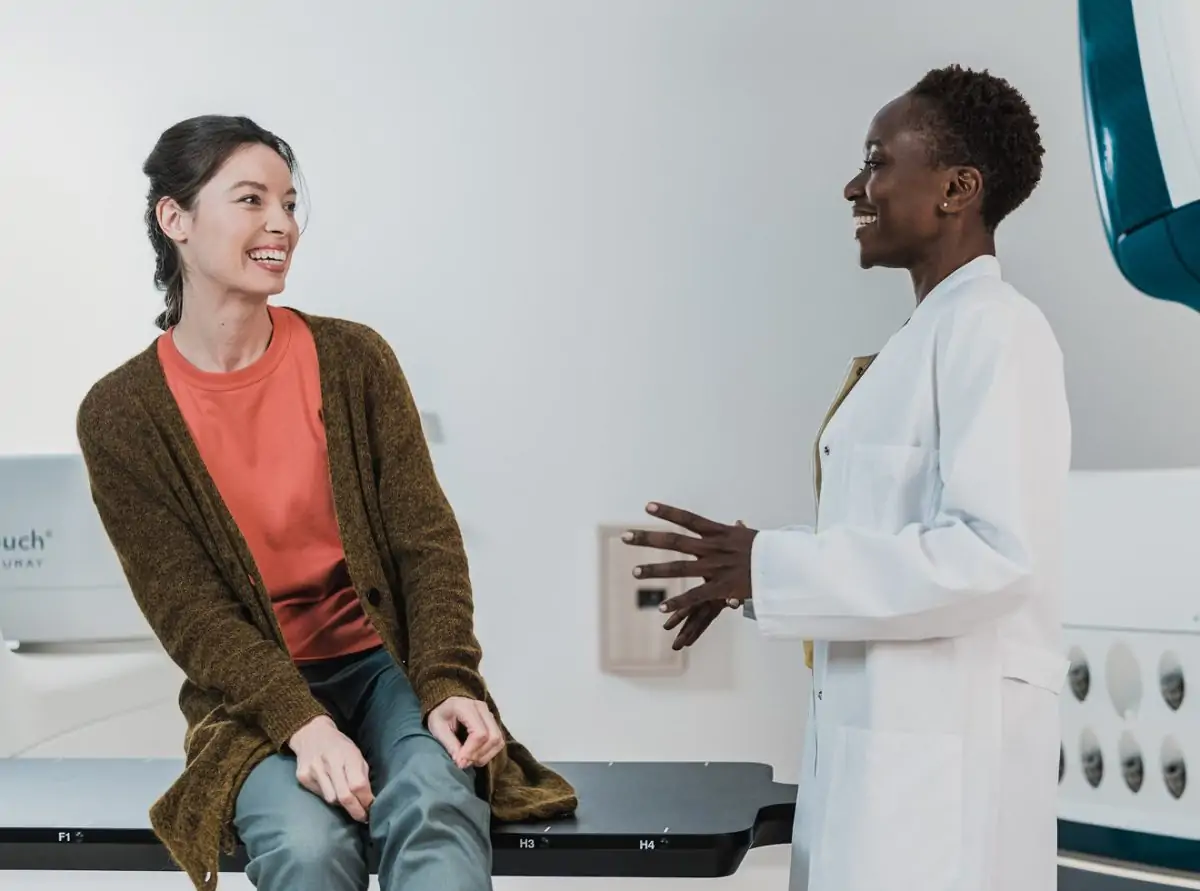 Smiling provider speaking with patient during a wellness visit, illustrating personalized care and trust.