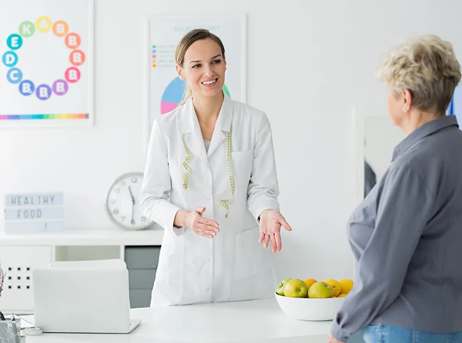 Nutritionist, dietician, or wellness provider counseling older female patient on healthy eating habits, highlighting lifestyle interventions and preventative care in chronic disease management