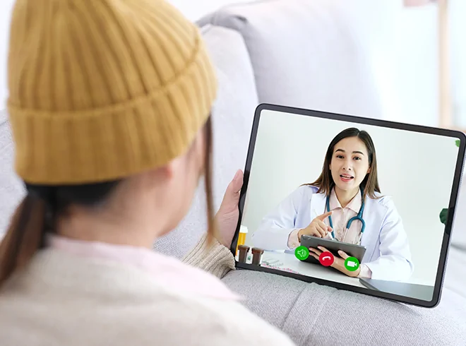 Patient using tablet for virtual consultation with female doctor, illustrating telehealth services, remote care delivery, and digital patient engagement