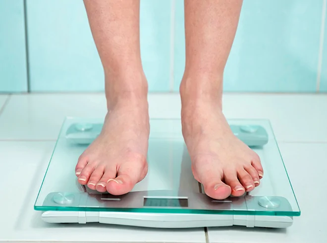 Close-up of person standing on digital scale, illustrating weight tracking for Remote Patient Monitoring (RPM) and Remote Therapeutic Monitoring (RTM) in chronic condition and obesity management